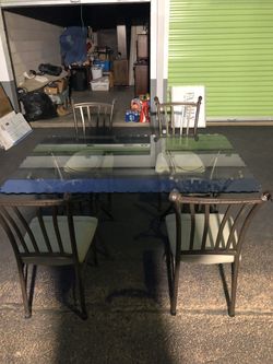 Glass table with chairs. Heavy etched glass and heavy metal