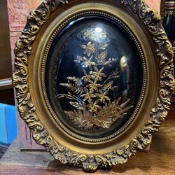 Hawaiian real flowers and leaves in frame and bubbled plastic