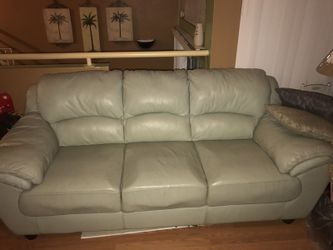 Mint green leather sofa from rooms to go like new.