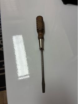 Vintage MAC Tools slotted screwdriver with a distinctive wooden handle.