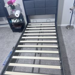 IKEA SLATTUM upholstered twin  bed frame in dark gray fabric. With mattresses ( two twin beds )