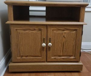 TV stand strong and heavy and has wheels