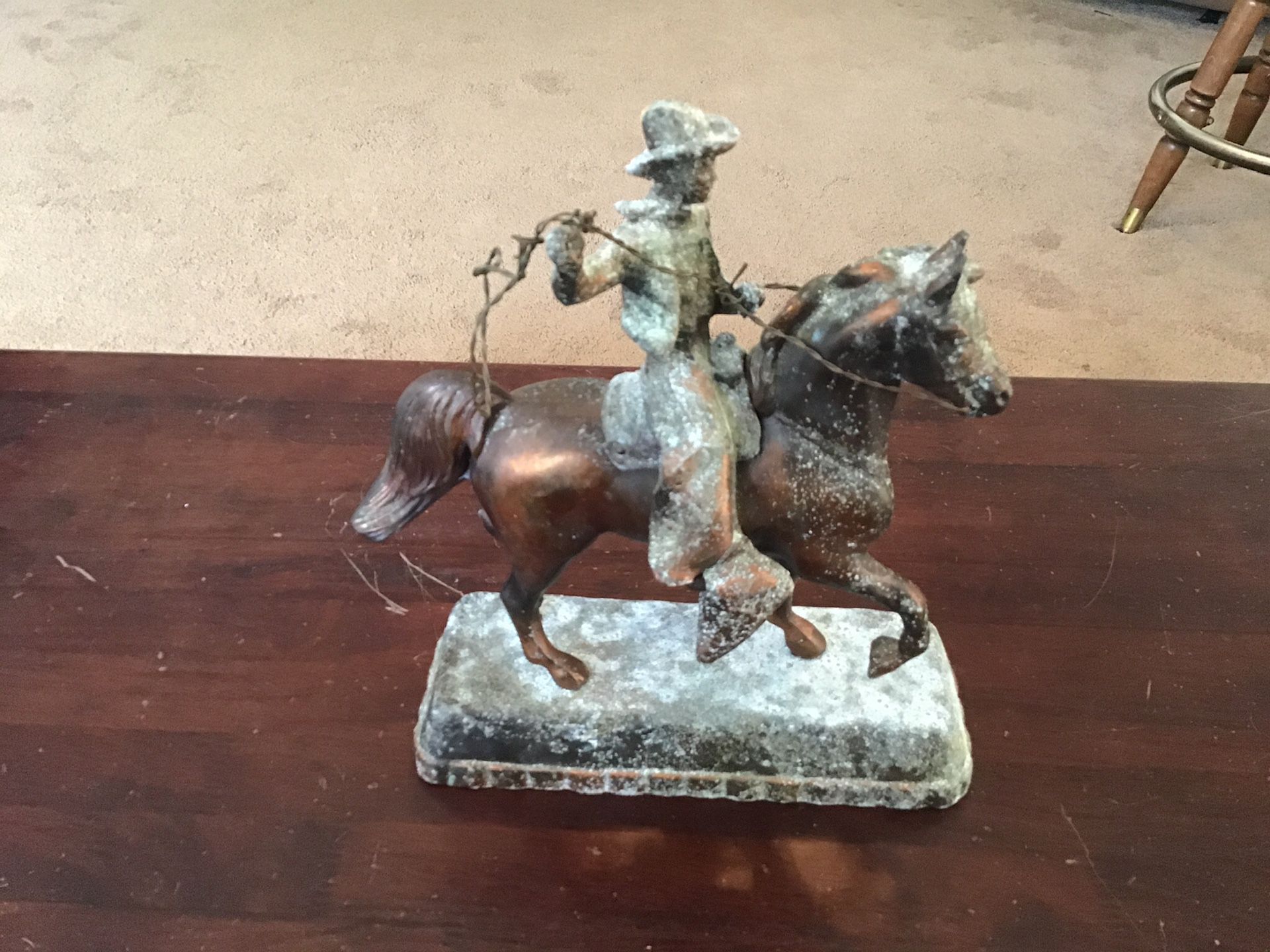 Vintage copper patina cowboy on a horse