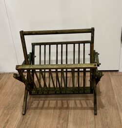 A vintage Hollywood Regency folding brass magazine rack