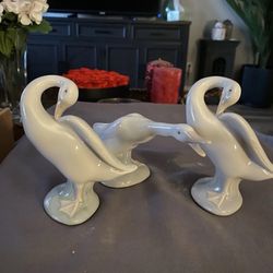 Elevate your space with a set of three large LLADRO geese figurines, crafted with meticulous attention to detail. These porcelain works of art, painte