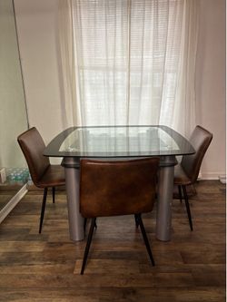 Glass dining room table with four chairs