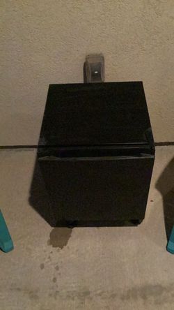 Small Refrigerator (works) with freezer section and adjustable leg stand to keep it off the floor.