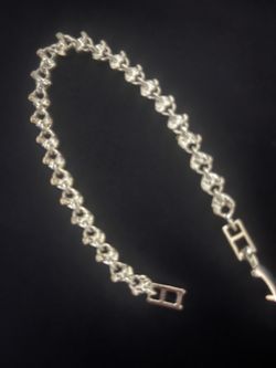 Elegant silver-toned Heart link Tennis bracelet with a textured finish. This piece is made of Hearts linked together and has a repeating link design. 
