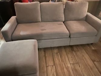 Gray apartment couch with ottoman