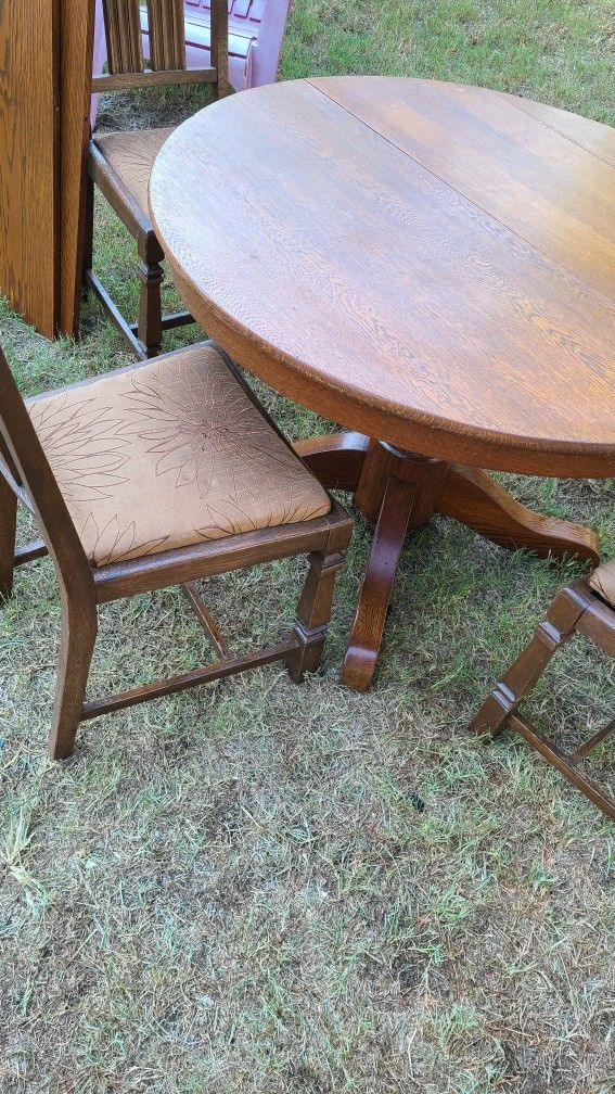 Antique heavy wooden round table and 4 chairs in excellent condition