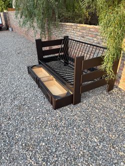 wooden futon/daybed frame with a metal seat frame and two under-bed storage drawers.