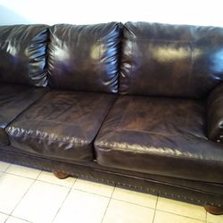 2 BROWN SOFAS & A WOOD TABLE (ONE BROWN SOFA IS RECLINABLE & IS IN OK CONDITION)