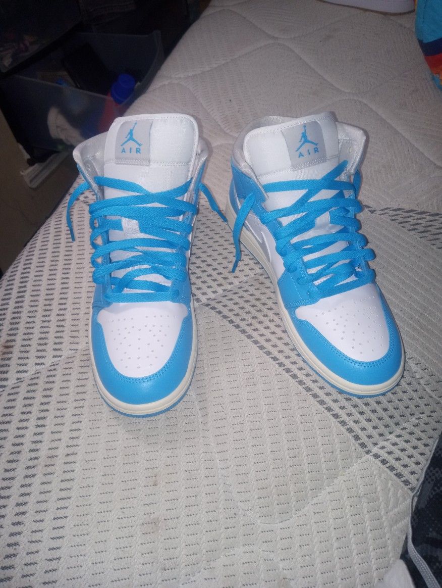 Air Jordan 1 Mid Light Blue, Grey Nike Logo, And White.