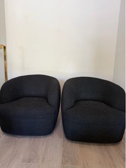 2 CB2 black boucle lounge chairs