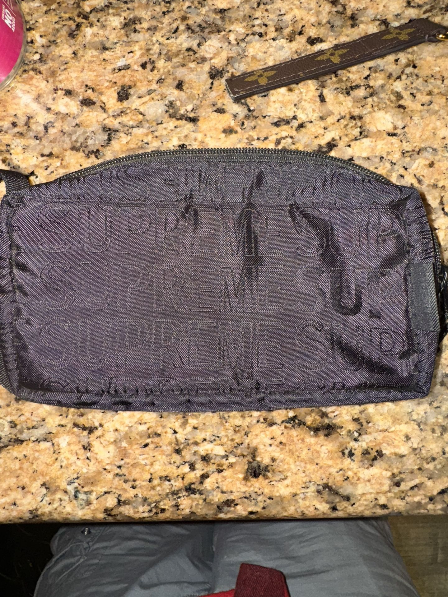 Supreme fanny pack, and Louis Vuitton keychain
