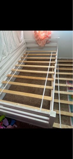 White double Twin Bed Frame with bottom roll out bed.
