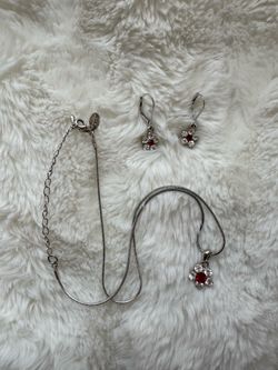 silver-toned jewelry set featuring a floral necklace & matching earrings adorned with red & clear stones ⋆. 𐙚 ˚