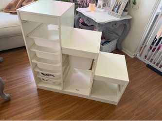 IKEA shelf with a couple totes