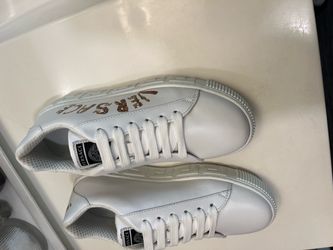 Versace La Greca calf-leather low-top sneakers in White + Gold.