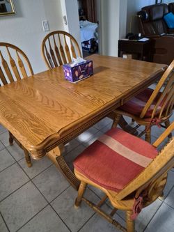 Heavy duty wood kitchen table with 4 solid chairs.