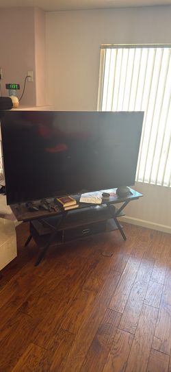 65" Roku with Stand, Soundbar, and remote for both.