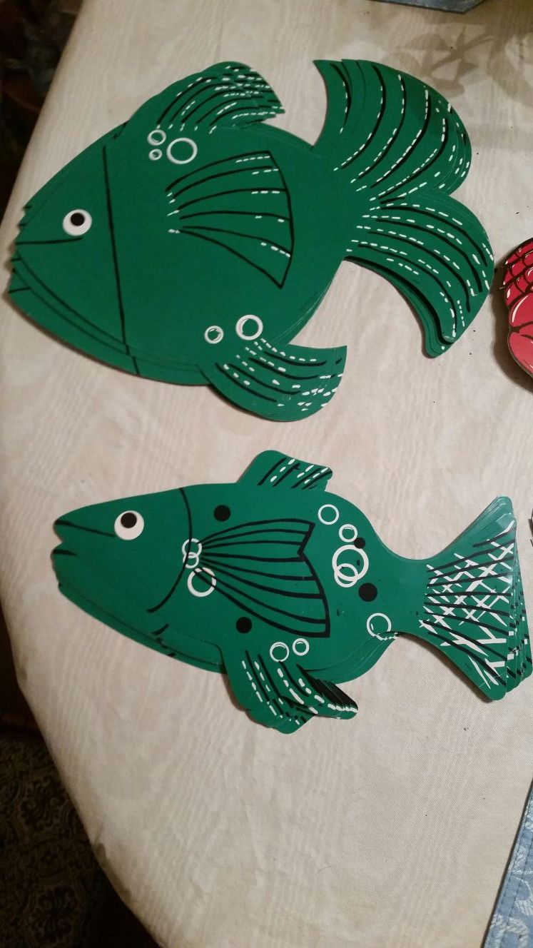 Cardboard sea animal cutouts with holes in the top for hanging