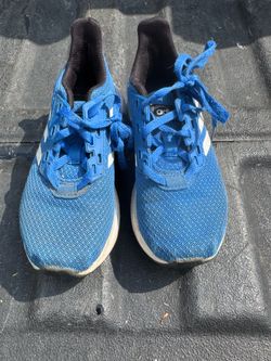 a pair of Adidas shoes in a children's size 11K