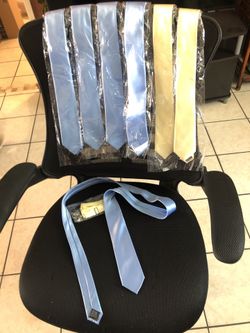 7 neckties, 5 blue 2 yellow, and yellow bowtie