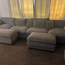 Grey couches with ottomans