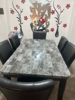 Dining table with 6 black leather chairs