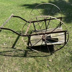 Antique milk can hauler. Iron wheels.