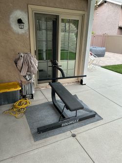 Soloflex workout machine and assorted weight plates