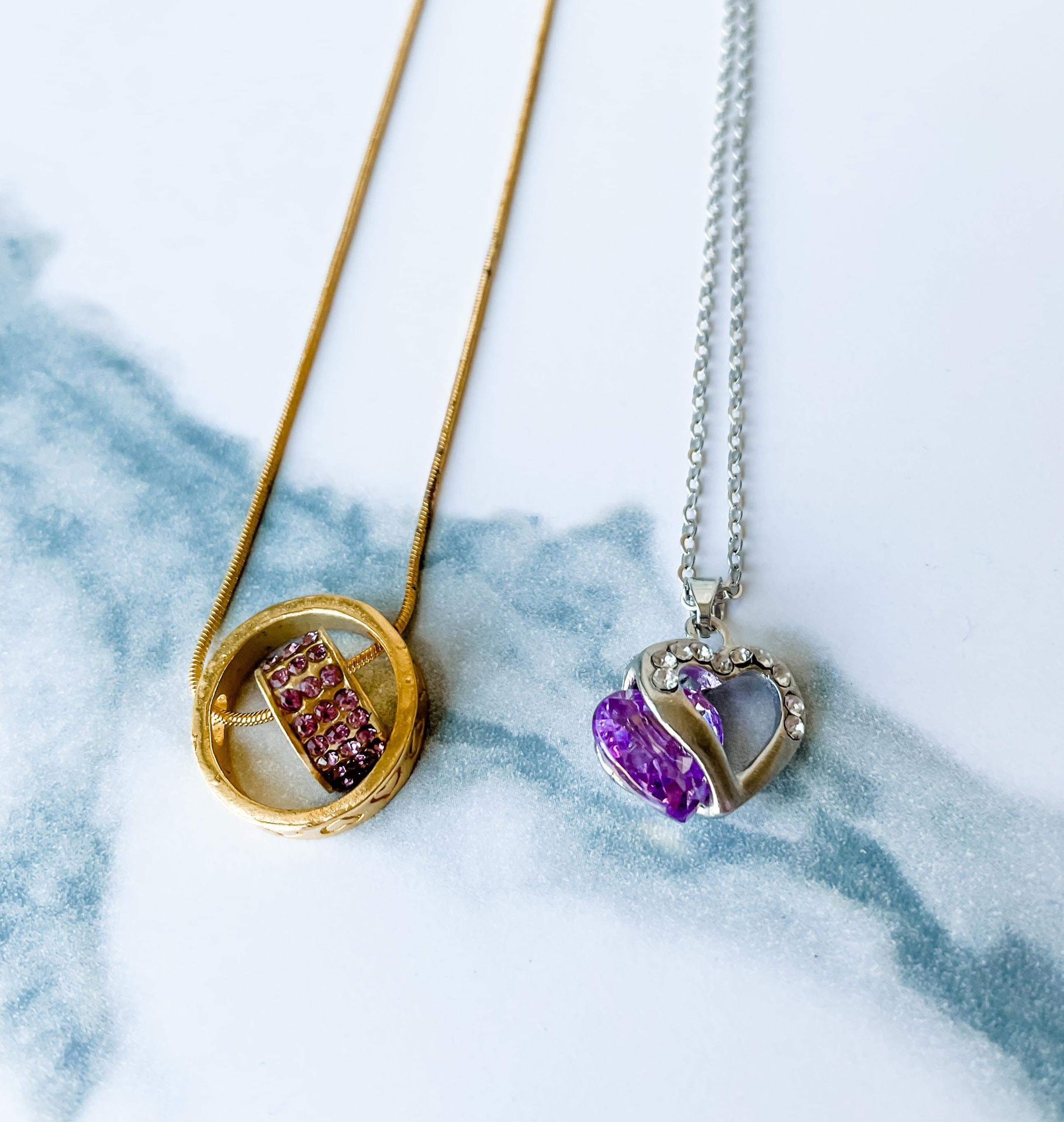 Two necklaces with purple gemstones