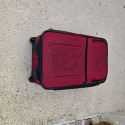 Vintage red 21 inch rolling carry on luggage, size 21 x13 x8. Multi zipper pockets. Has some marks from use, all zippers and wheels work good. Local p