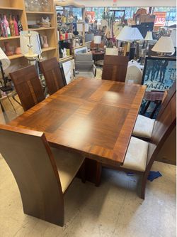 Gorgeous distinct dark wood table with an extendable leaf and beige upholstered chairs - 68” x 44” no leaf