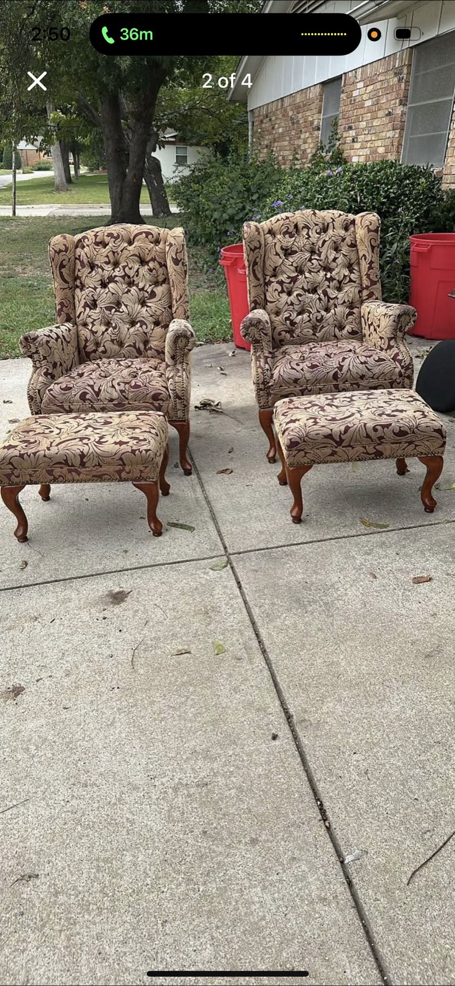 A Pair Of Wingback Chairs With Ottomans