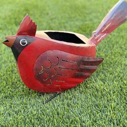 Garden sculpture in the shape of a cardinal made from recycled metal.