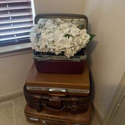 Stacked Vintage Luggage With Floral Arrangement 