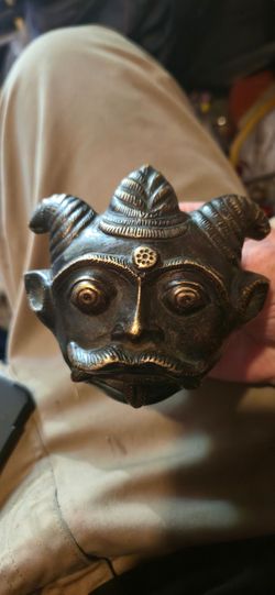 Very old solid brass mask temple offering