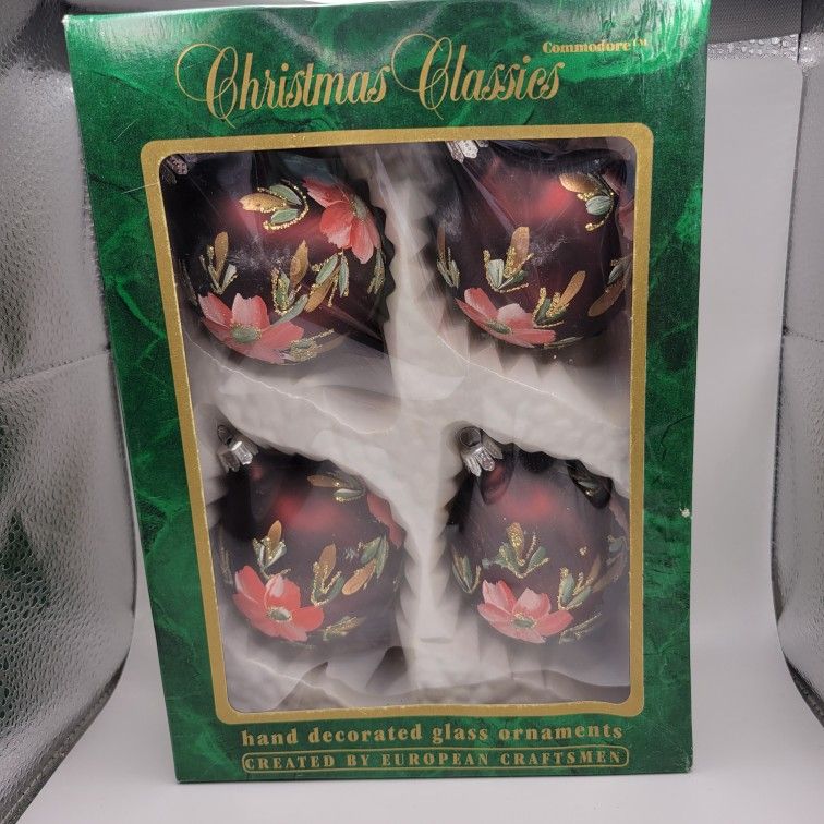 Add some vintage charm to your Christmas decorations with this set of 4 hand-decorated glass ornaments from Christmas Classics. The round ornaments co