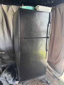 Black GE top-freezer refrigerator