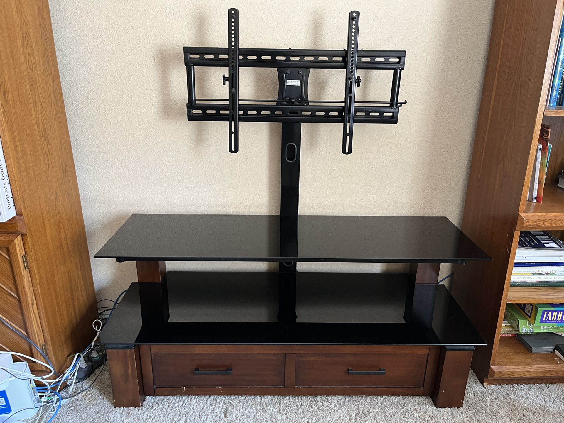 Entertainment center, wood cabinet with two black glass shelves, and rotating TV mount