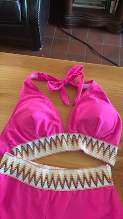 This hot pink two-piece swimsuit is a high-waisted bikini set featuring a distinctive tribal contrast detail.