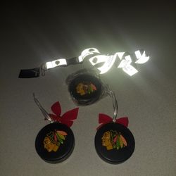 CHICAGO BLACKHAWKS LOT OF TWO PUCK ORNAMENTS, ONE SEALED PUCK ALL LIGHT NOT REAL PUCKS AND ONE LANYARD NEW WITH TAG