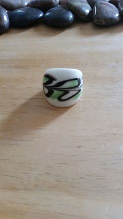 White green and black glass ring