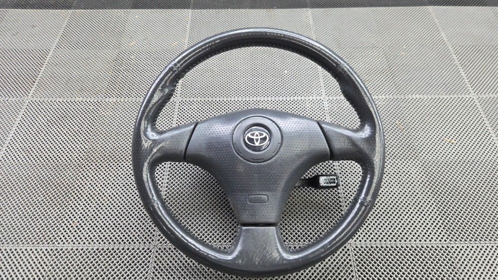 Toyota 3 Spoke Leather Wrapped Steering Wheel With Airbag.