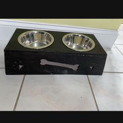 Raised wooden dog feeder One of the dishes has some rust $8  or Free with another purchase 