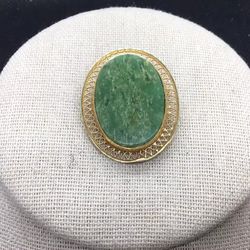 This Vintage Pin is 1/20 12K Gold Filled and measures 1 1/2 inches long. This is Beautiful with a green Jade stone and is signed "Burt Cassell".