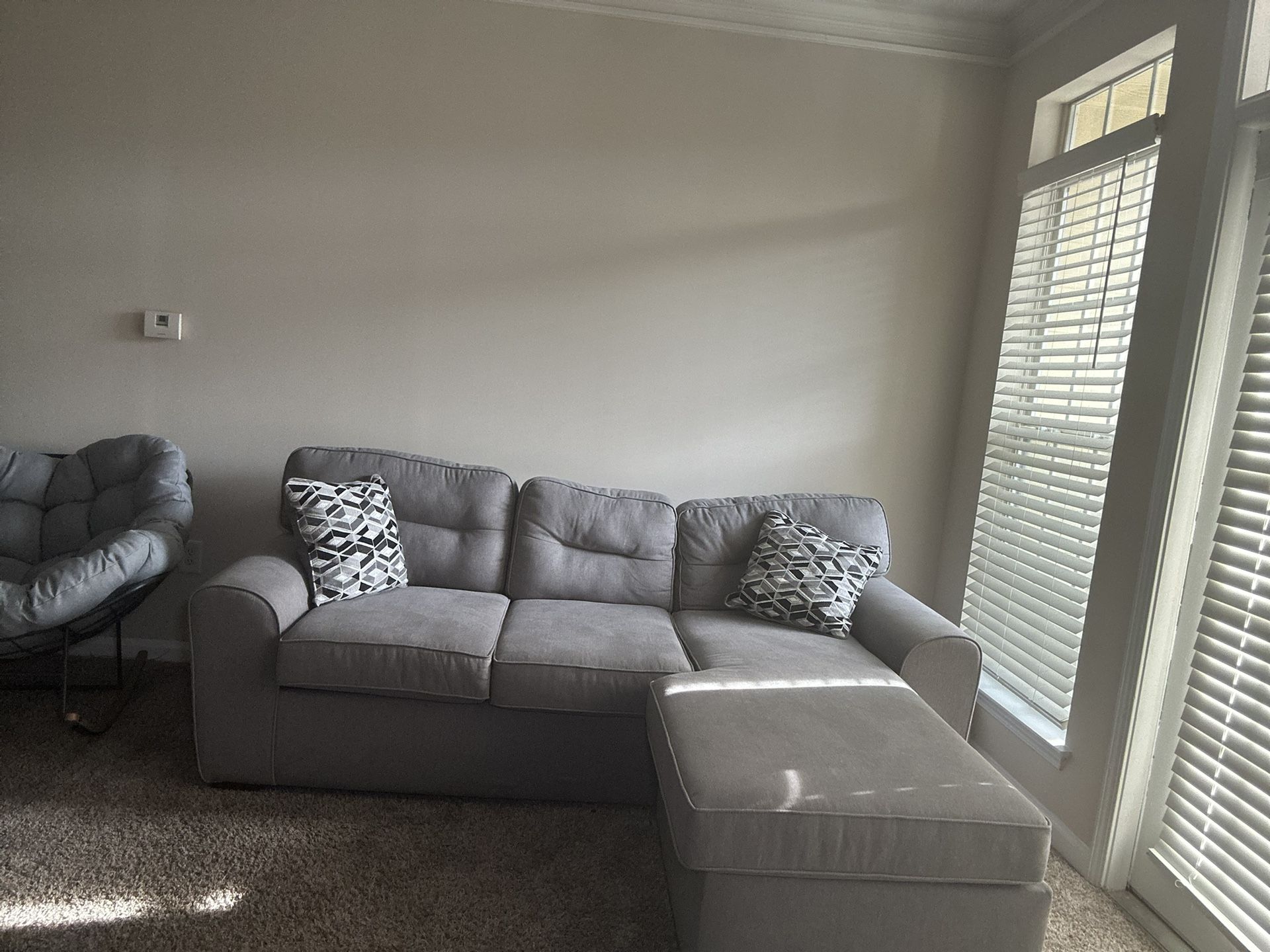 Grey Couch With Two Pillows
