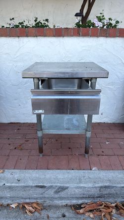 NSF Professional-grade commercial bar station featuring a stainless steel work surface, built-in dump sink/waste chute, lower undershelf for storage, 